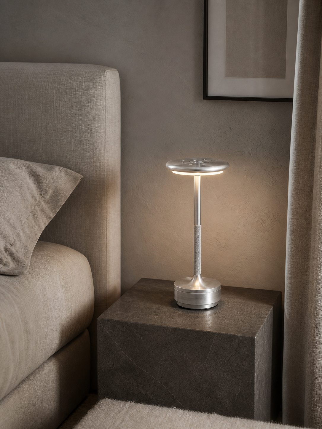 Silver Atlas cordless table lamp on a stone bedside table