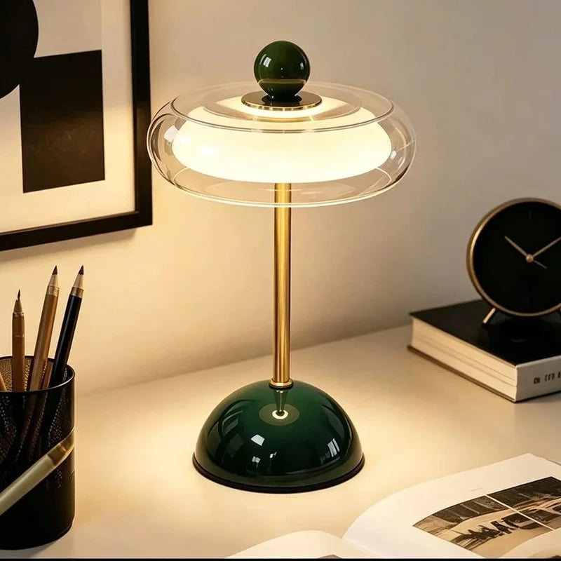 Green Sorrel cordless glass lamp glowing on a desk