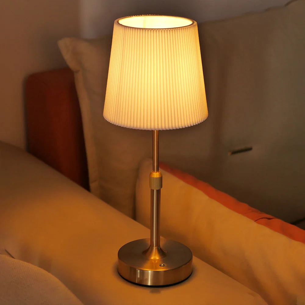 Gold Linden cordless fabric shade lamp glowing in a warm interior