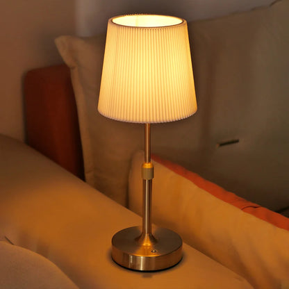 Gold Linden cordless fabric shade lamp glowing in a warm interior