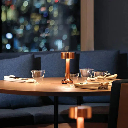 Odile copper cordless drum lamp in a restaurant booth