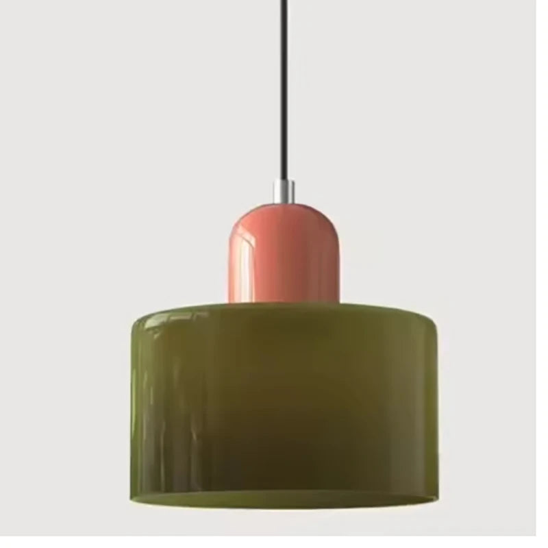 Close view of an olive Mira glass pendant with a coral top
