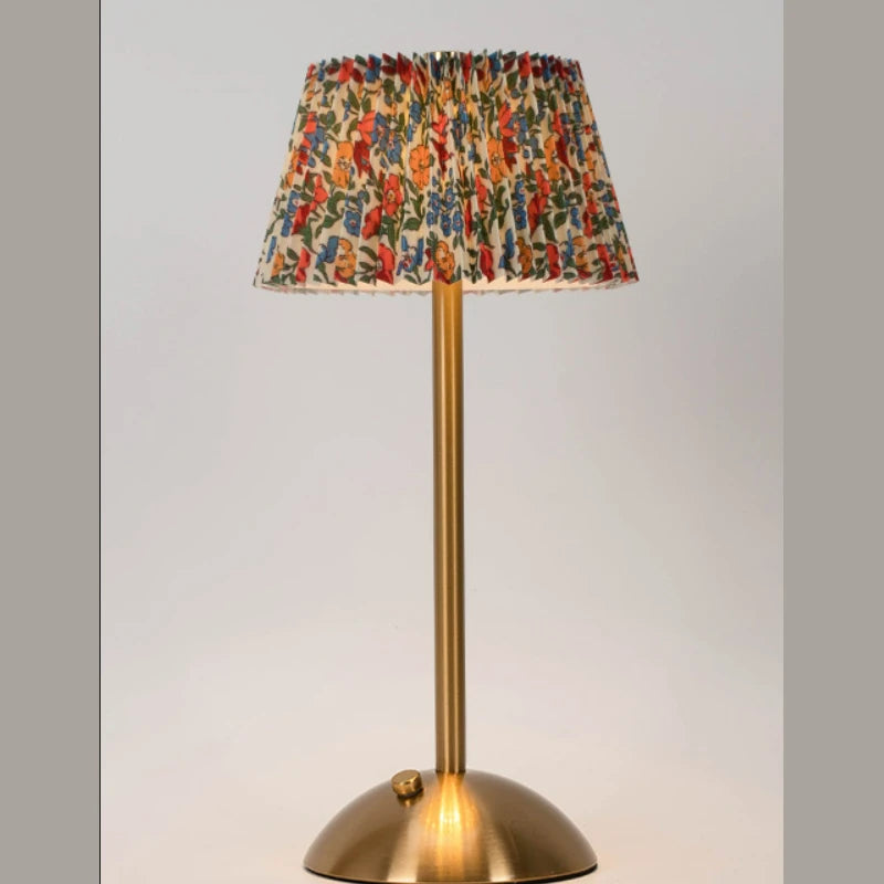 Elara lamp with a multicolor floral pleated shade on a neutral backdrop