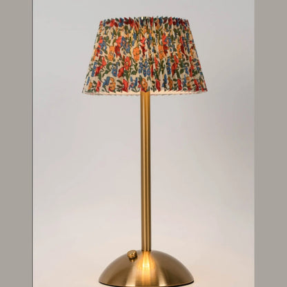 Elara lamp with a multicolor floral pleated shade on a neutral backdrop