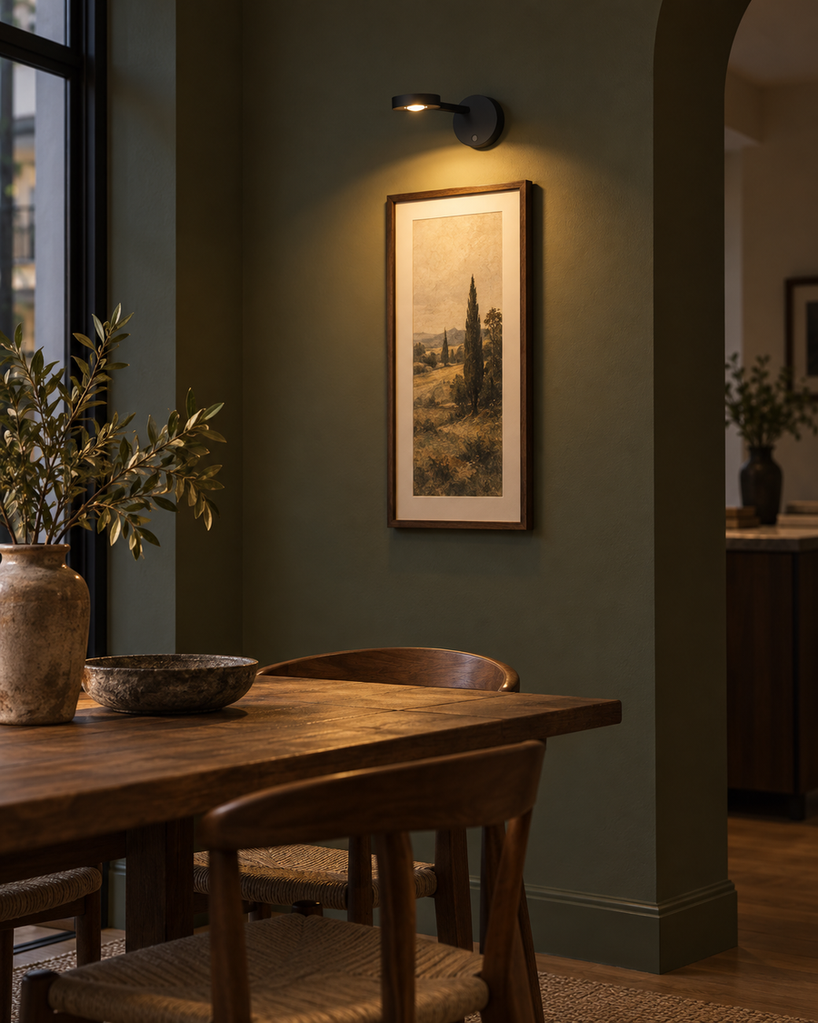 Black Liora rechargeable picture light above framed artwork in a dining nook