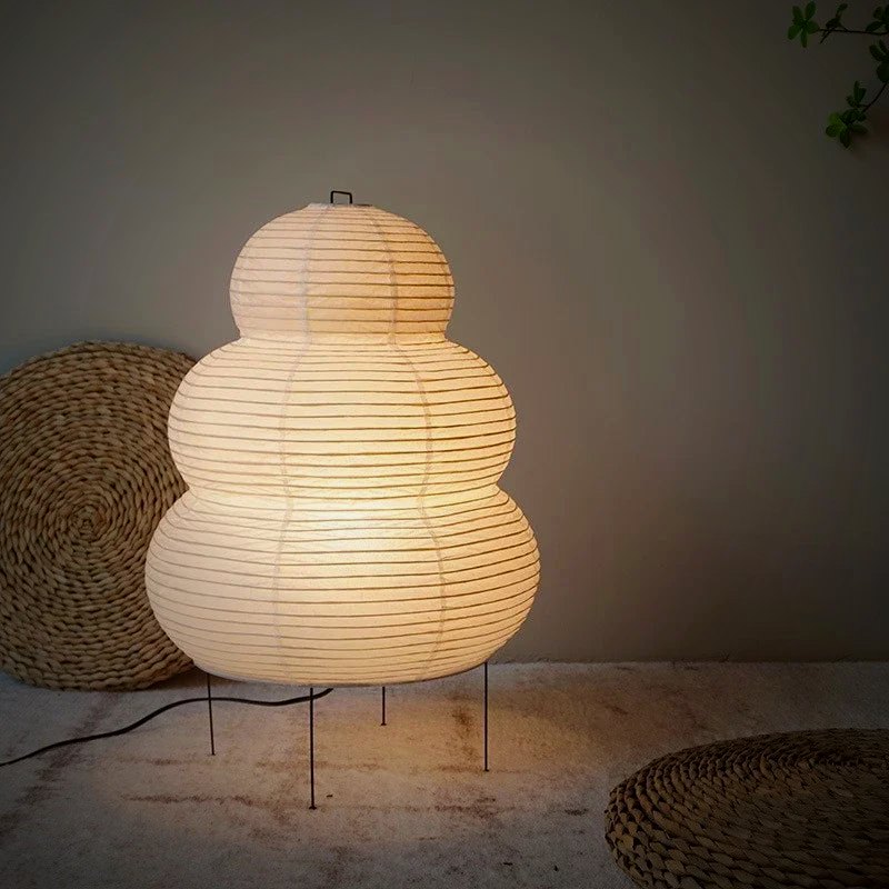 Mochi Japanese paper table lamp glowing on a wood table