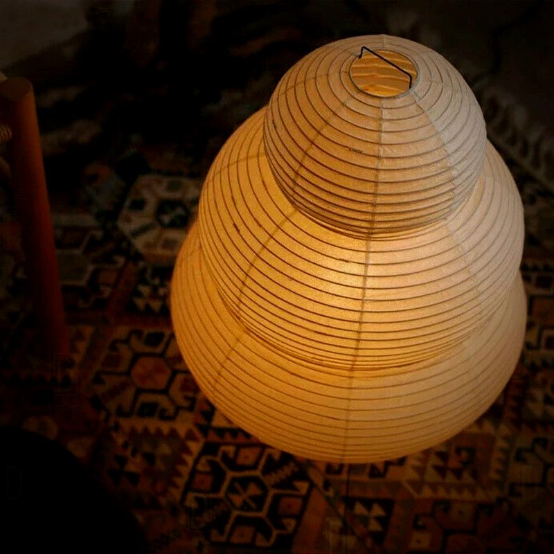 Close view of the Mochi lamp's three glowing Japanese paper tiers