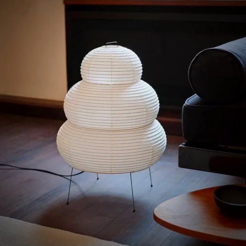 Mochi lamp lit on a side table next to a sofa