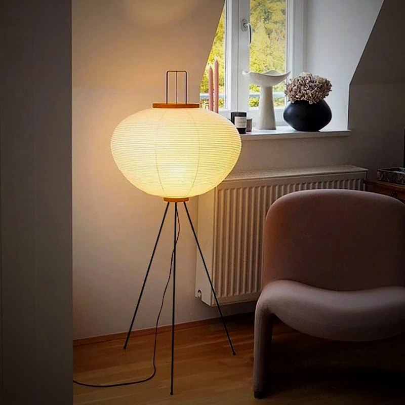 Nara floor lamp beside an armchair