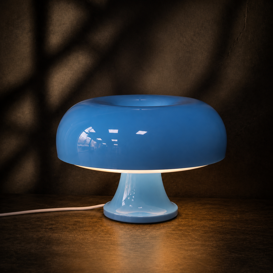 Blue Oslo mushroom table lamp glowing against a dark backdrop