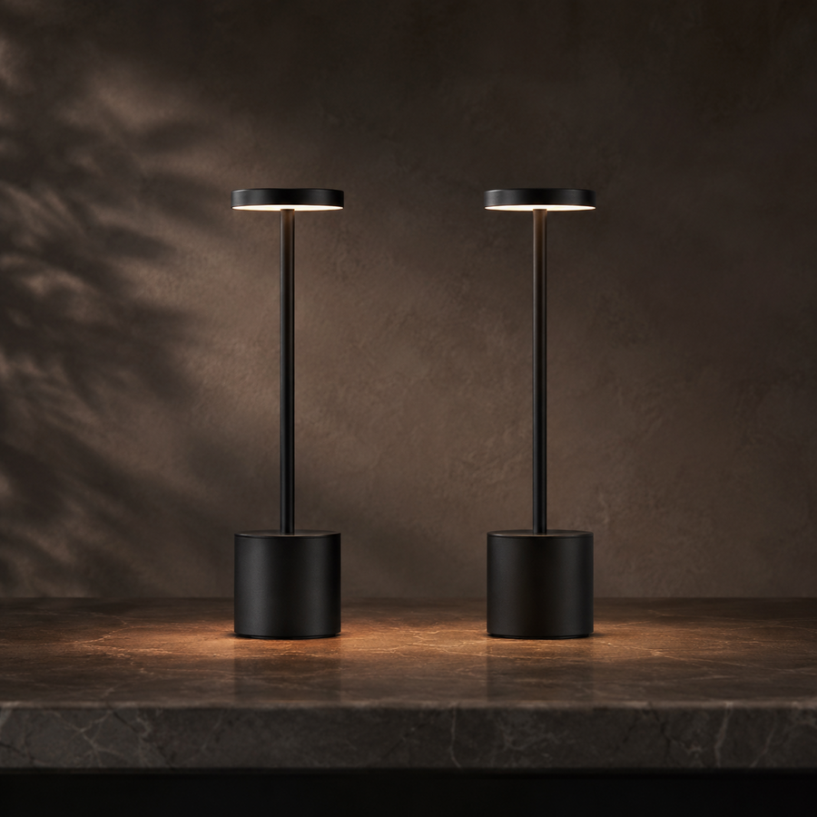 Ember Vesper cordless table lamps in matte black on stone at dusk